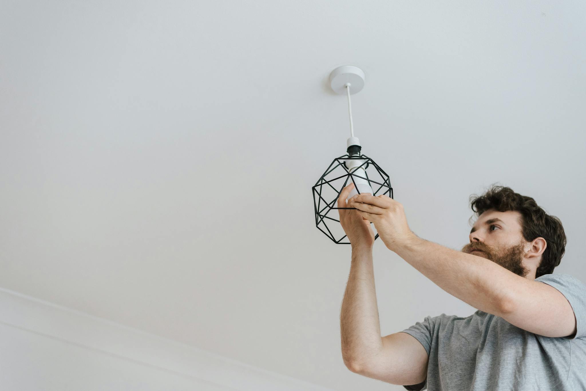 A Professional Electrician Skillfully Installing A Modern