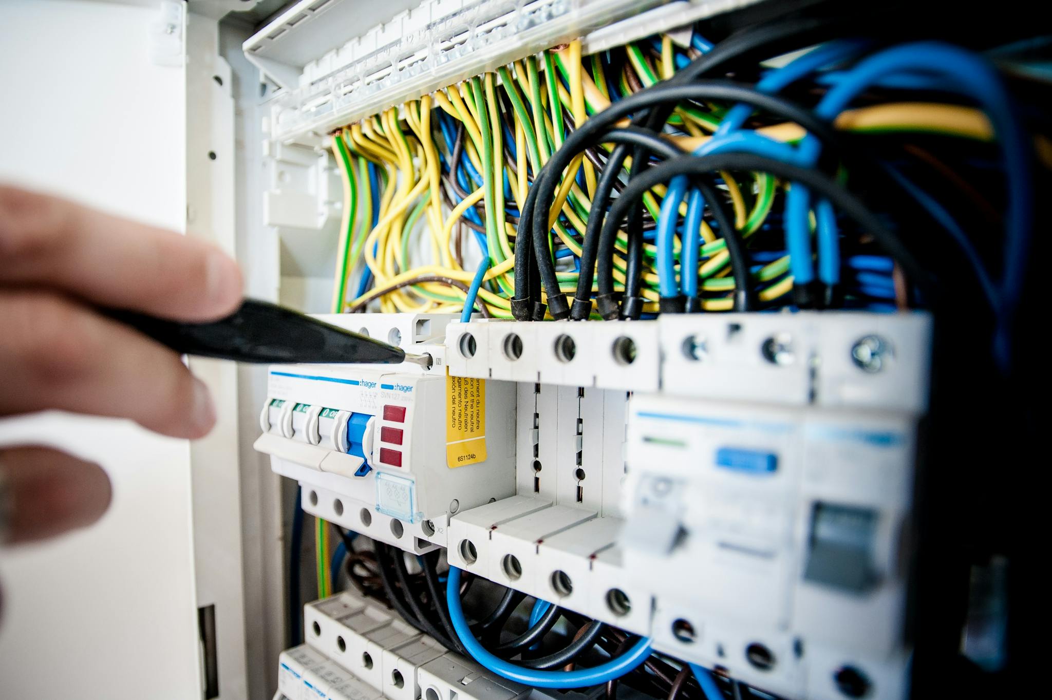 Hand Of Electrician Working On A Circuit